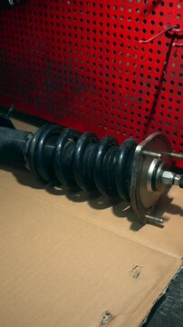 A pre-assembled car shock absorber with a spring for installation on a vehicle. Car suspension. Shock absorber. Spring.
