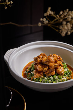 Braised Spare Ribs,White tableware for Chinese food in a Chinese restaurant, simple composition with floral background