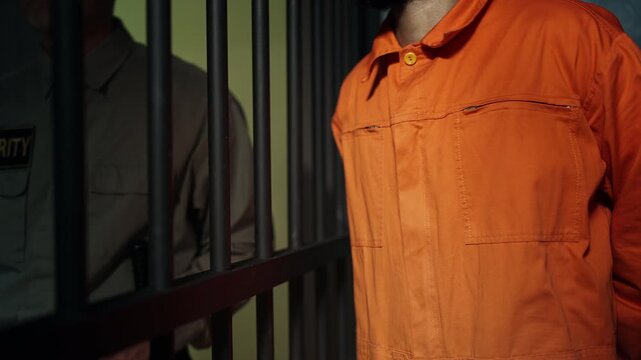African American prisoner giving money to dishonest guard, corruption in prison