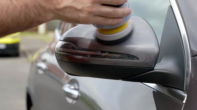 Polishing silver SUV mirror with small dual action machine polisher