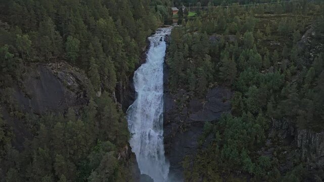 Norway Latefossen Waterfall flowing across rocky alpine landscape