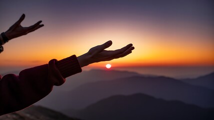 Extended Hands Reaching Toward Vibrant Sunset Over Layered Mountains