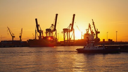 Shipping port at sunrise with silhouettes of industrial cranes and cargo ships against a glowing sky, symbolizing global trade, maritime logistics, and international sea ocean transportation networks