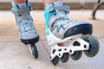 Closeup detail of roller skate wheels in motion on pavement, outdoor sport and recreation,...
