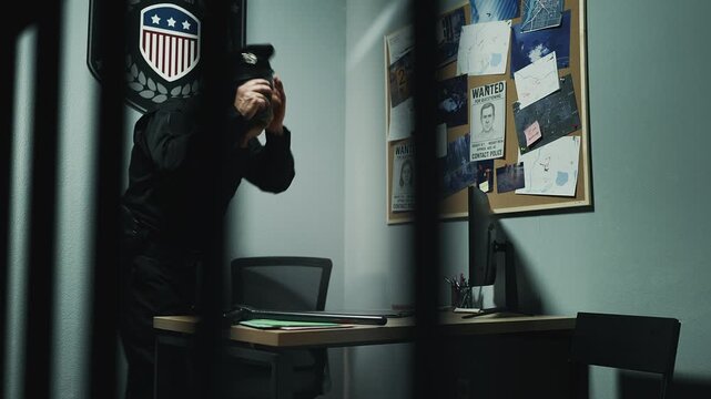 Middle-aged officer writing crime report while working in police station office