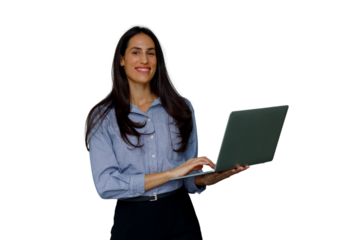 Young businesswoman standing, smiling and typing on laptop, working and using wireless technology