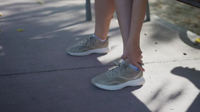 Woman runner suffering ankle injury outdoors