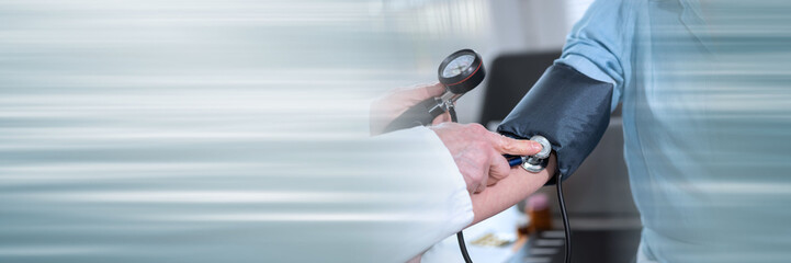 Blood pressure measurement of a female patient; panoramic banner