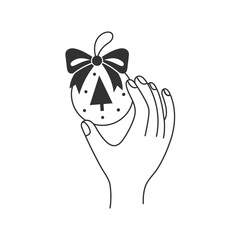 Hand Holding Ornament with Tree and Bow. Modern line art of palm showing round Christmas ball with small fir and ribbon. Doodle Vector illustration for holiday branding, invitations, and packaging.