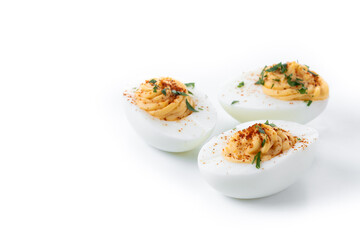 Homemade hard Boiled Deviled Eggs garnished with herbs isolated on white background. Copy space
