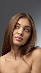 Fototapeta premium Portrait of woman with bare skin and soft gaze representing modern natural beauty. Concept of beauty industry, editorial aesthetics, self-esteem, and media advertising trends.