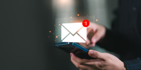A person checking a smartphone with a glowing new email notification icon, representing digital communication, email marketing, online messaging, and business connection technology.