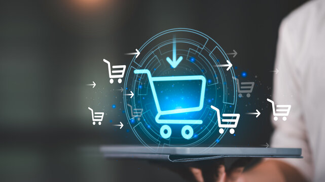 Businessman using a digital tablet with glowing shopping cart icons, representing e-commerce, online shopping, digital marketing, business growth, and modern retail technology.