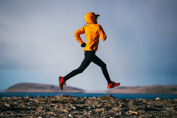 Woman runner running at the winter high altitude lakeside, Tibet