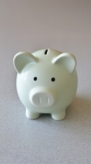 Cute ceramic piggy bank in soft pastel color, designed for saving money, placed on a smooth surface, symbolizing financial planning and savings goals for individuals