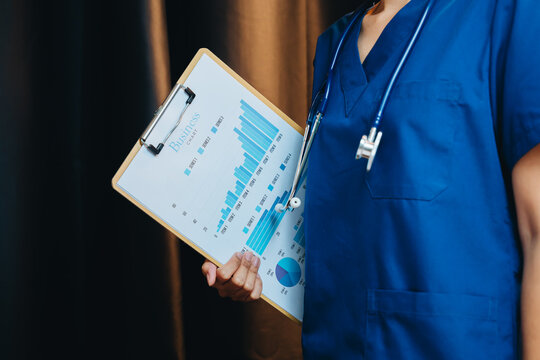 Healthcare analytics concept. Healthcare Professional Analyzing Medical Data with Stethoscope and Chart in Clinic Setting