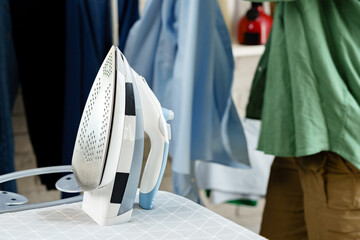 Ironing clothes in a well-lit laundry room for a fresh look and tidy appearance