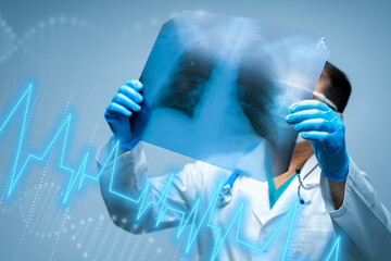 Doctor examines lung X-ray with digital health data display in a modern medical setting