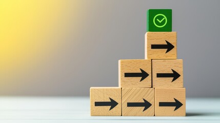 A stack of wooden blocks with arrows, topped by a green block with a checkmark, symbolizing progress and direction in a minimalist setting.