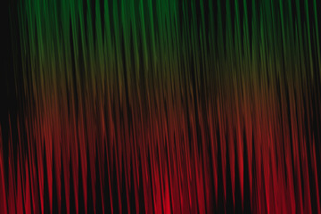 Abstract vertical stripes of green and red light with dark background