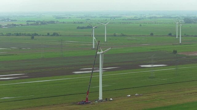 High angle view of wind tower maintenance with man and large crane
