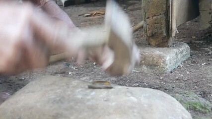 Close up of man's hand using hammer for small iron repair