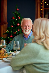 Joyful Grandfather At Christmas Dinner With Family Celebrating New Year Together, Warmth And Friendship