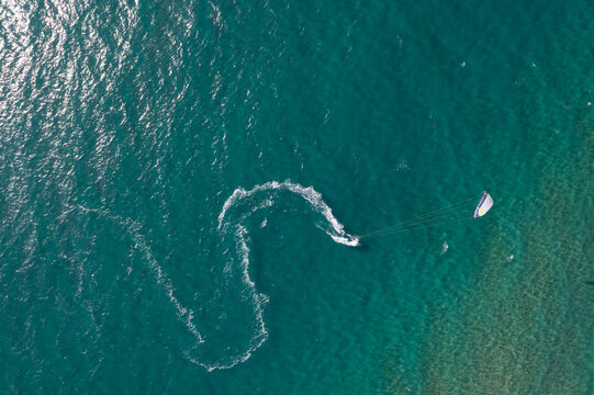 Kitesurfer making turn in turquoise sea