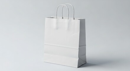 A plain white paper shopping bag stands isolated against a clean, light background.