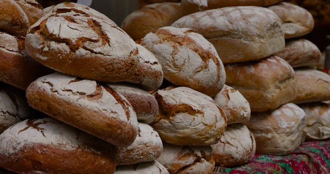 Freshly baked rustic bread loaves arranged in a natural pattern. Variety of textures and grains, ideal for culinary, organic, or bakery visuals.