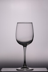 Tall wine glass, empty, photographed against the light