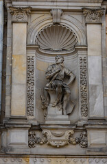 Baroque bas-relief with a sculpture of a seated man made of stone