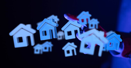 Abstract 3D rendering of house icons held in a hand, symbolizing concepts like real estate, home ownership, or housing market. Great for financi