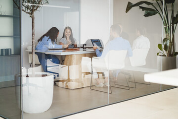 Multiracial colleagues working inside business office with glass walls - Entrepreneurs people sharing ideas at teamwork meeting - Brainstorming concept - Main focus on asian girl face
