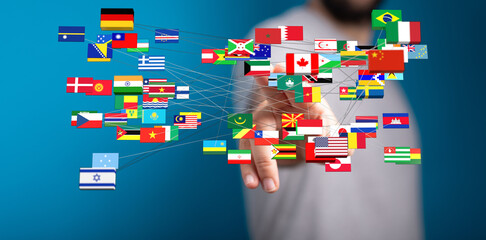 Obraz premium Diverse flags connected to a hand, representing global connections, unity, travel, and international relations. A visual metaphor for globalizat