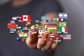 Concept of globalization, international relations, and global community symbolized by flags held in...