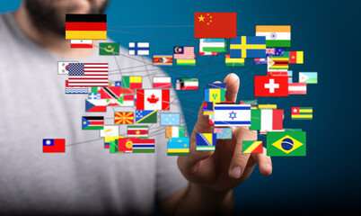 A person's hand interacts with a network of international flags representing global connections, teamwork, and international relations.