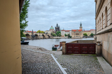Famous wooden door on the Vltava River bank with Prague Old Town across the river, Czech Republic