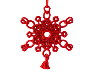 Red, ornate, macrame snowflake ornament with a tassel, suspended in the air
