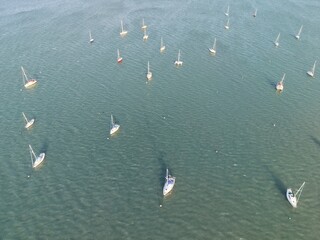 Aerial top view of boats and yachts in marina from above. Yacht parking, A marina lot, Yacht and sailboat is moored at the quay, Aerial view by drone.