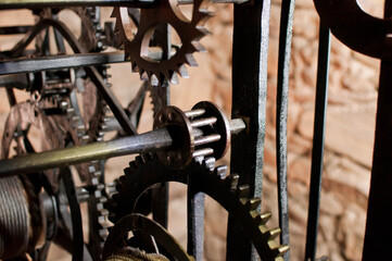 Antique church clock mechanism with metal gears. Perfect for illustrating vintage machinery, time concepts, history, or industrial design.