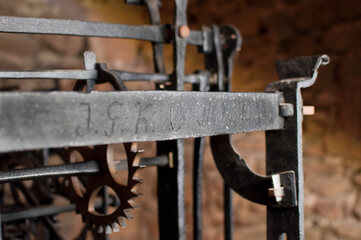 Antique church clock mechanism with metal gears. Perfect for illustrating vintage machinery, time concepts, history, or industrial design.