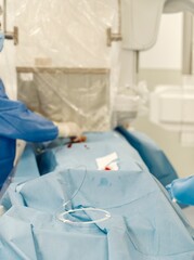 In a sterile clinical environment, healthcare professionals prepare for a procedure involving innovative drug-eluting microspheres designed for targeted cancer therapy in the liver