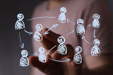 A human hand touches a glowing virtual network of stylized people icons with connecting arrows, symbolizing social communication and business re