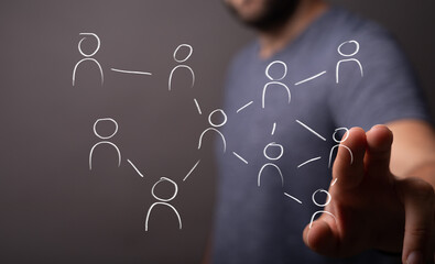 Professional's hand touching a virtual screen with interconnected user icons, symbolizing digital networking, social connections, and business c