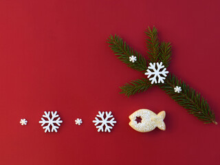 Christmas composition with linzer cookie in a shape of fish, spruce twig and snowflakes, copy space for text