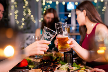  Friends having fun clinking glasses with beer