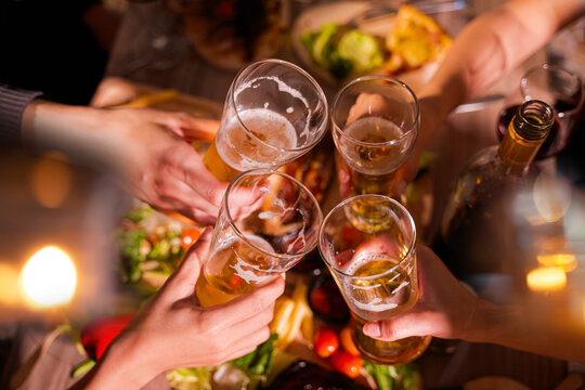  Friends having fun clinking glasses with beer