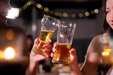 food and drink male friends are happy drinking beer and clinking glasses at a bar or pub.