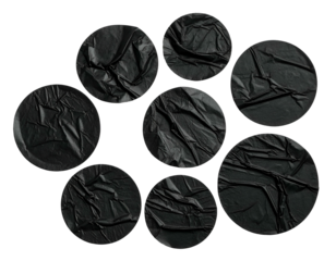 Composition of circular, wrinkled black fabric patches against a black background